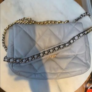 Gray quilted bag with gold and silver hardware